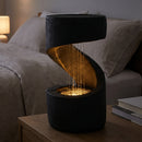 14" Winding Showers Tabletop Fountain – Black (spa) — Black Winding Showers tabletop fountain with warm LED lighting in a relaxing spa-inspired setting.