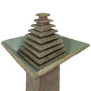 Close-up view of an outdoor pedestal fountain featuring a tiered pyramid water feature and square basin.