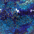 Crackled glass mosaic of a gazing globe in deep ocean blue hues.