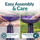 Crackled Glass Mosaic Bird Bath in iridescent purple shown being assembled and cleaned outdoors. The bowl twists securely onto the pedestal without tools, and the glass surface can be wiped clean with a damp cloth.