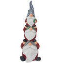 Stacked Christmas gnome statue with three gnomes wearing patterned blue hats, red and green clothing, and white beards on a white background