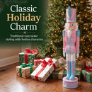 Pink Kristoff Christmas Nutcracker shown beside a decorated Christmas tree and wrapped gifts, featuring traditional nutcracker styling that adds classic holiday charm to a festive indoor space.
