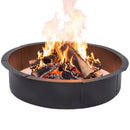 Black circular metal fire pit filled with burning logs, glowing embers, and flames, shown on a white background.