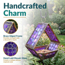 Modern Mosaic Fly-Through Bird Feeder in iridescent purple shown hanging in a garden, featuring a brass-edged frame and hand-laid mosaic glass for a decorative artisan-style design.