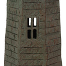 Close-up of a weathered brown and green lighthouse statue showing a four-pane cutout window and brick-textured finish.