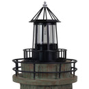 Close-up of a weathered brown and green lighthouse statue featuring a black lantern, glass enclosure, and metal railing against a white background.