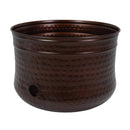 Hammered Iron Hose Pot in bronze, featuring a rounded metal design with a textured hammered finish, rolled rim, and side opening for convenient hose access.