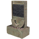Outdoor wall fountain with a textured rectangular water feature, semicircular basin, decorative rocks, and a lower rectangular reservoir.