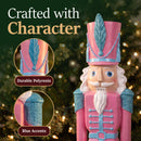 Pink Kristoff Christmas Nutcracker shown in a festive holiday setting, highlighting durable polyresin construction and decorative blue accents on the hat and shoulders.