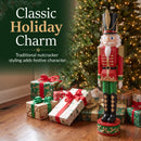 Red and green Kristoff Christmas Nutcracker shown beside a decorated Christmas tree and wrapped gifts, featuring traditional nutcracker styling that adds classic holiday charm to a festive indoor space.