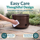 Bronze Hammered Iron Hose Pot shown being wiped clean with a soft cloth, highlighting simple maintenance and recommended indoor storage during freezing temperatures.